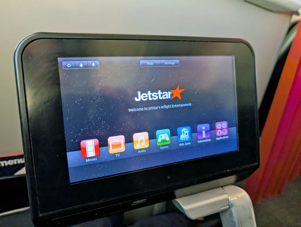 Jetstar Economy Review: Melbourne to Singapore 12 An in-flight entertainment screen on a Jetstar airplane displays options for movies, TV, audio, games, kids zone, information, and playlists.